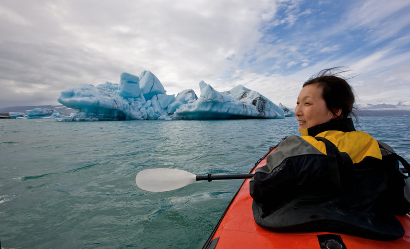 Single woman on kayak travel adventure